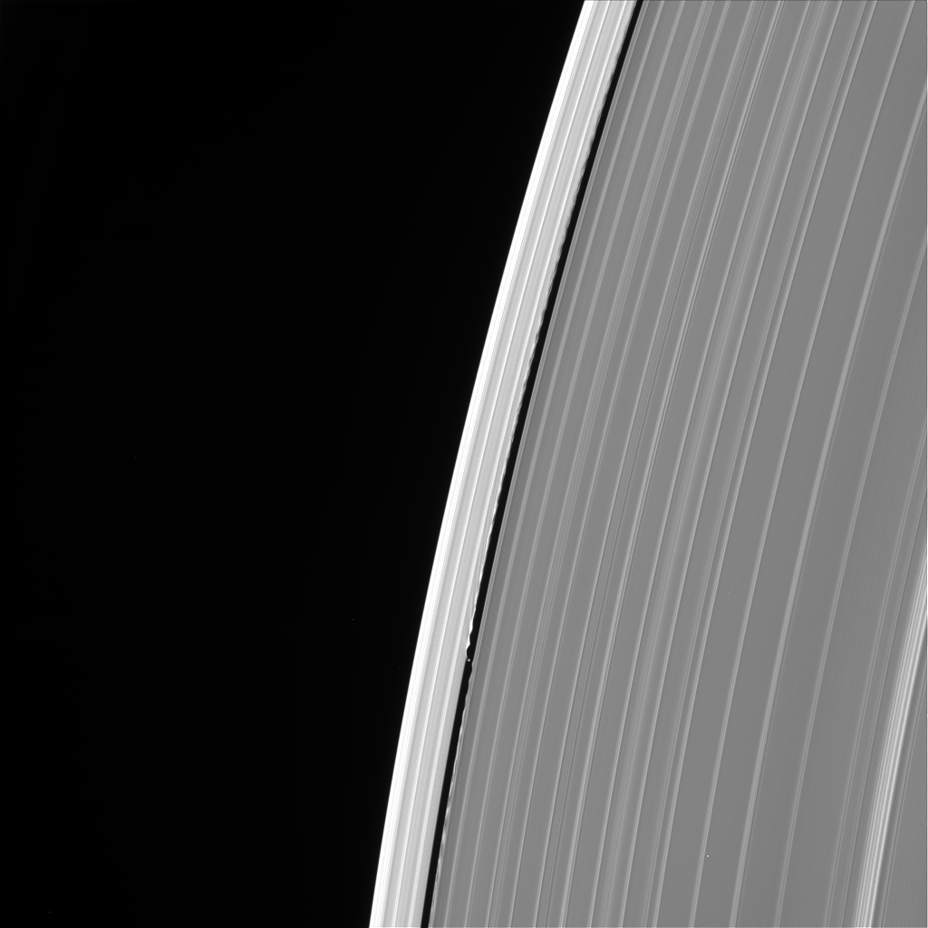Black and white image of Saturn's rings and the moon Daphnis.