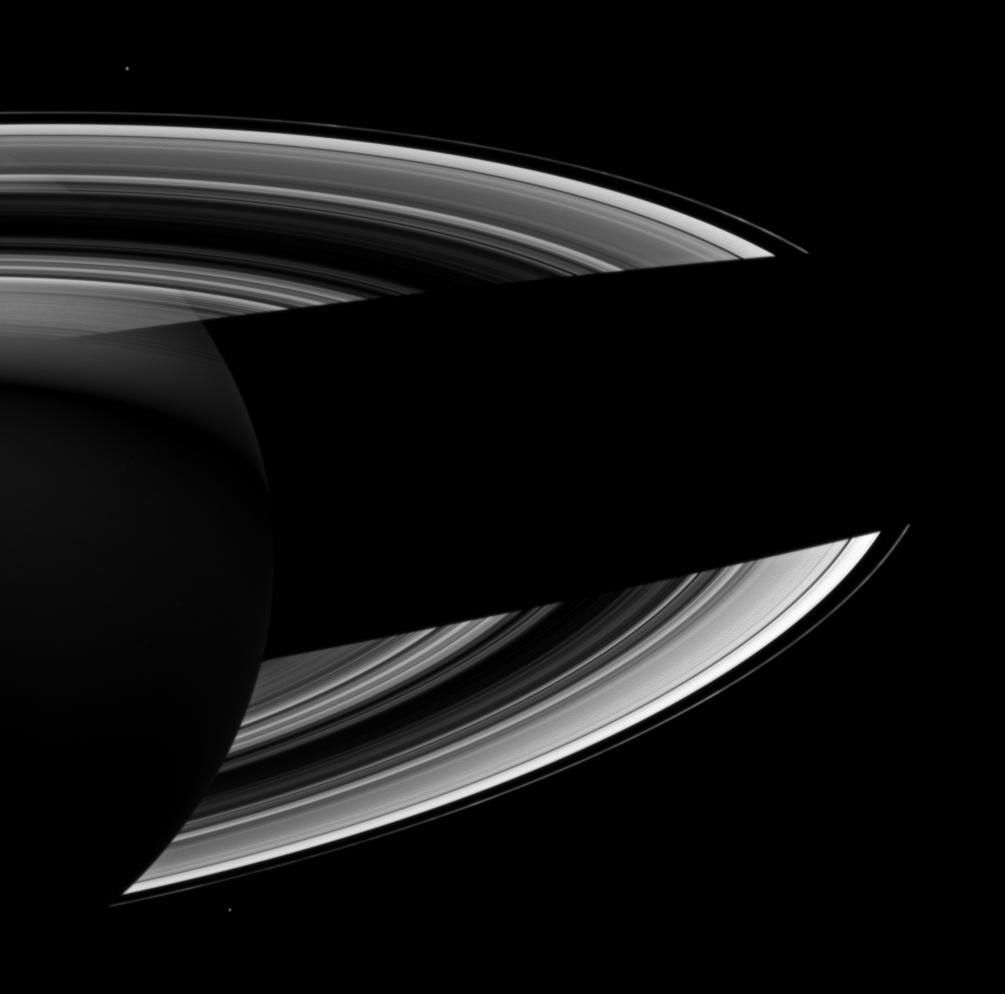 Saturn casts a wide shadow across its rings in this Cassini spacecraft view which looks toward the darkened southern hemisphere of the night side of the planet.