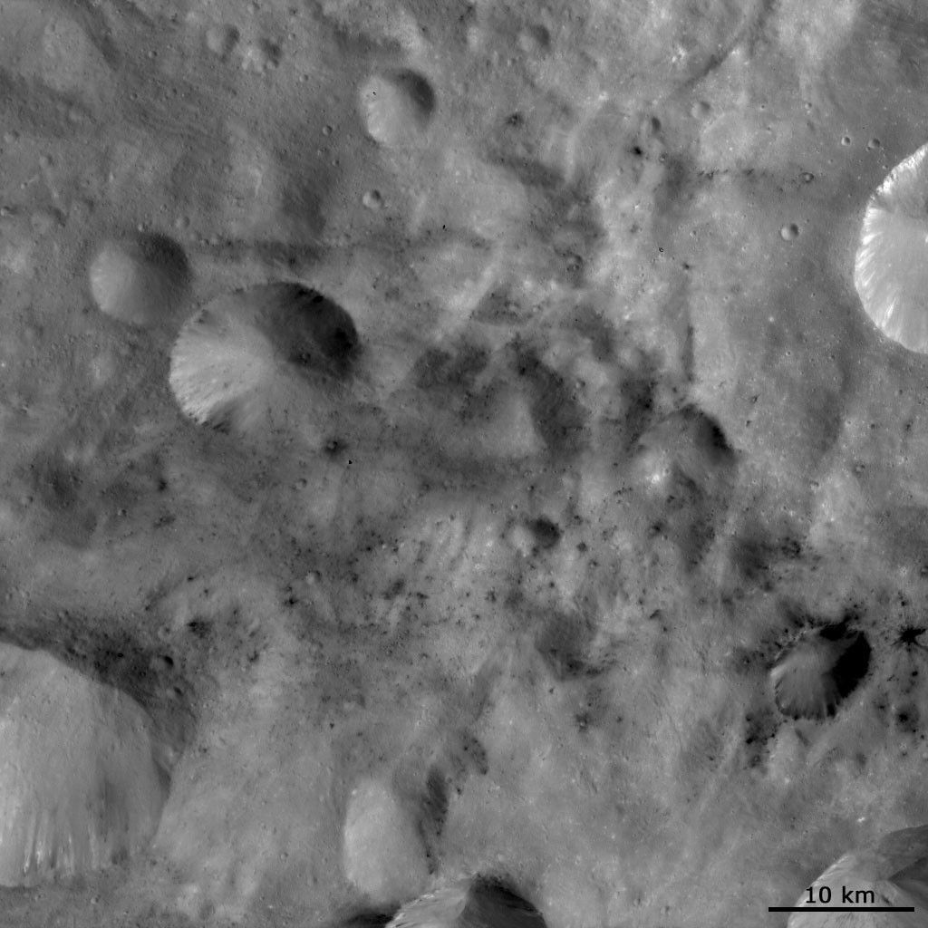 Dark Material Associated with and between Craters