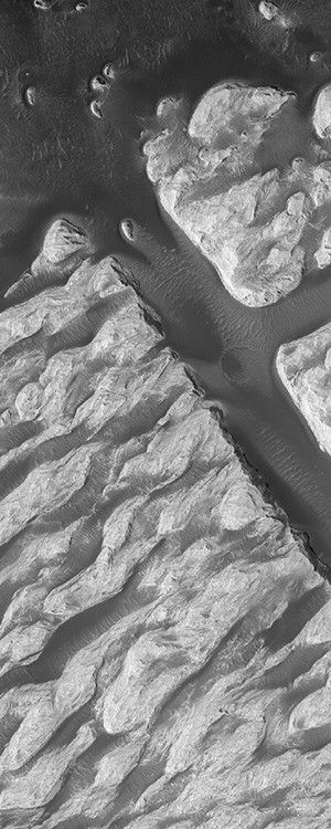 This Mars Global Surveyor (MGS) Mars Orbiter Camera (MOC) image shows a portion of the famous "White Rock" feature in Pollack Crater in the Sinus Sabaeus region of Mars.