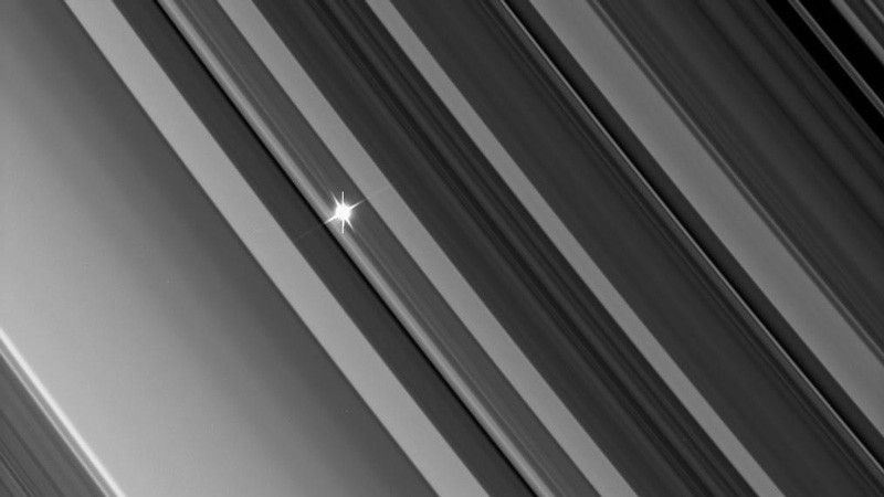 A distant star through the dense B ring.