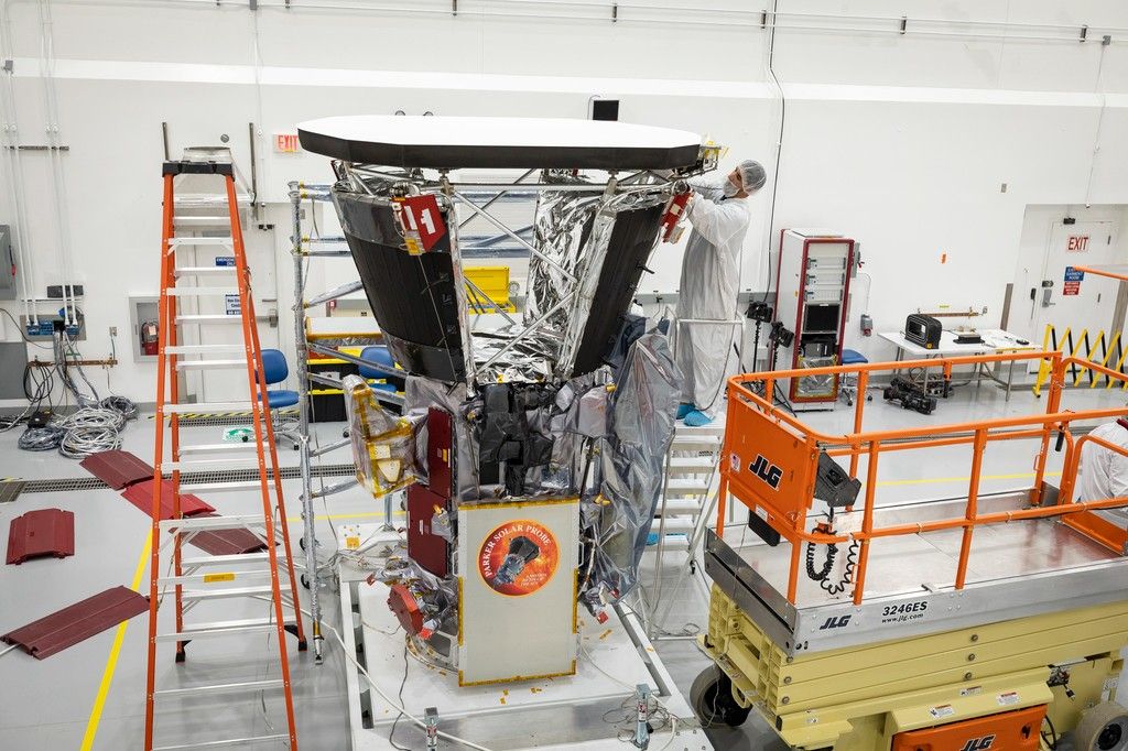 workers constructing spacecraft in clean room