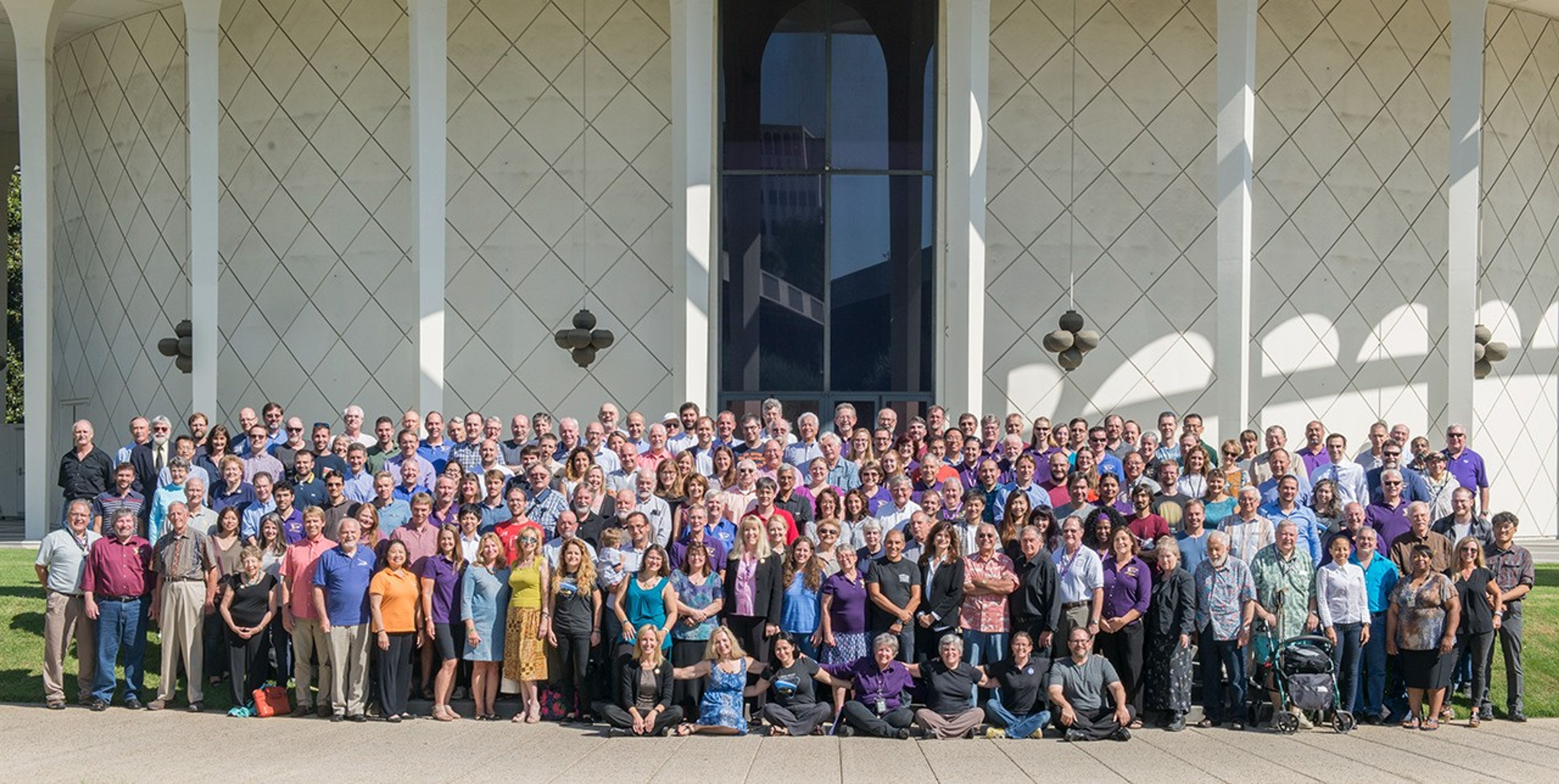 Color image of a large group of people smiling.