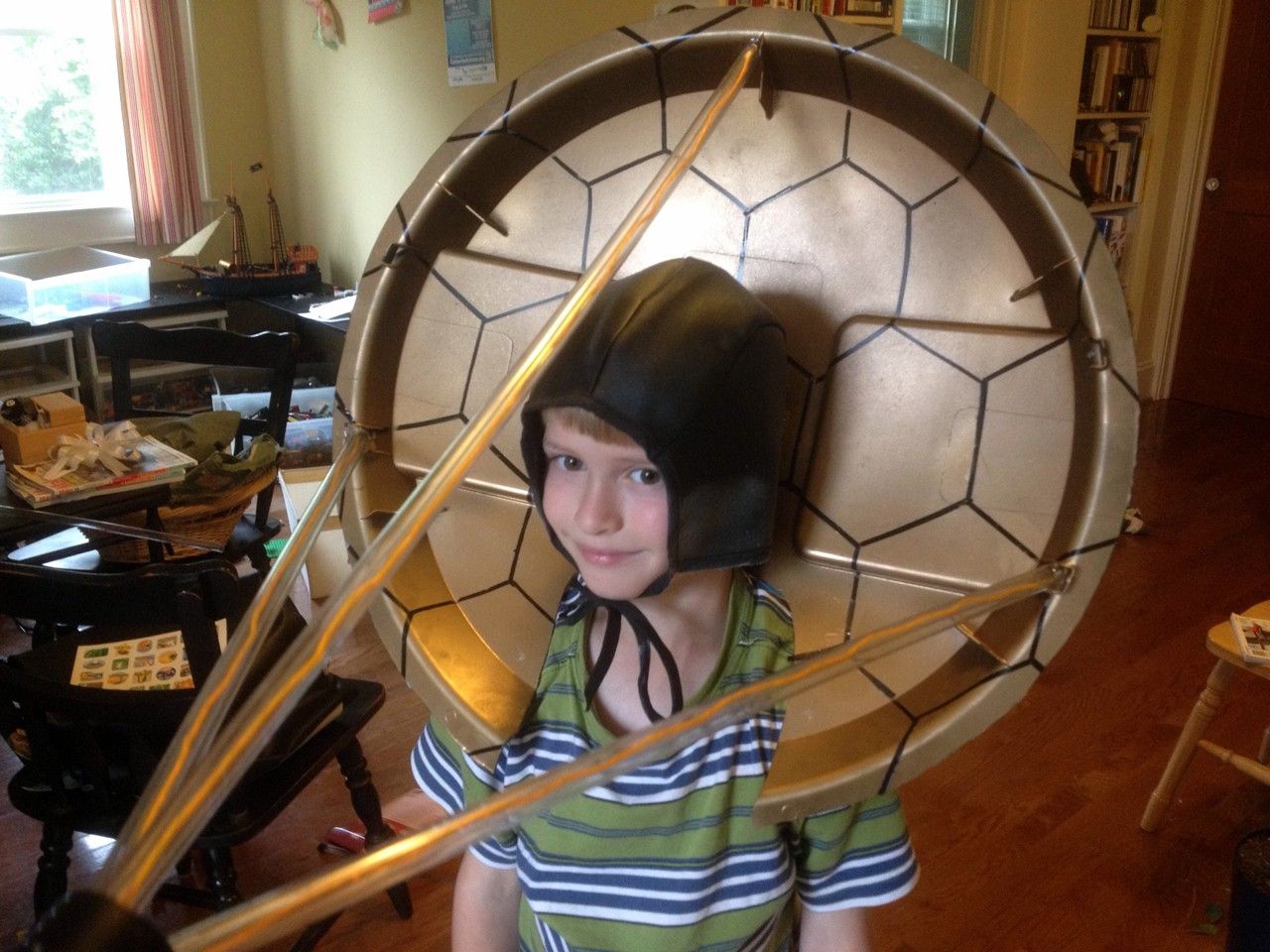 Little boy wearing spacecraft costume.