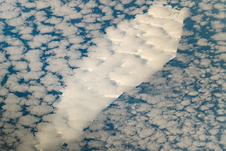 Iceberg under clouds that looks like a coffin.
