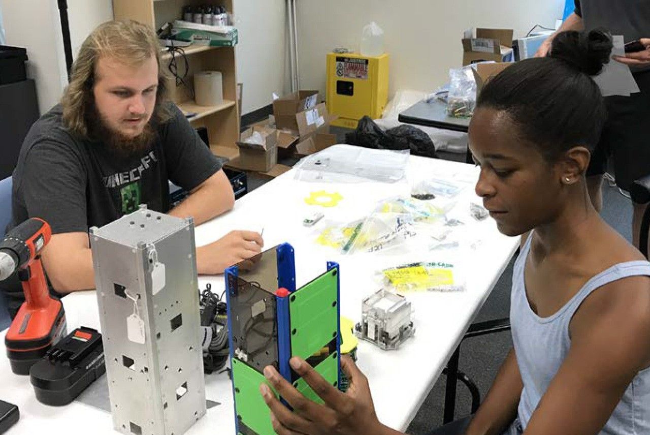 Two students with CubeSat