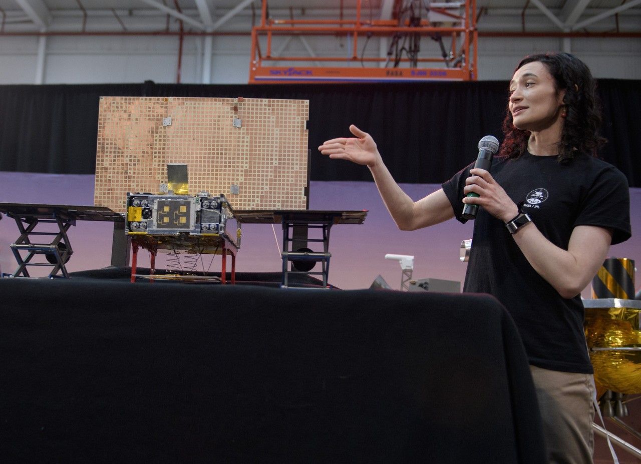 Woman and MarCO spacecraft model.