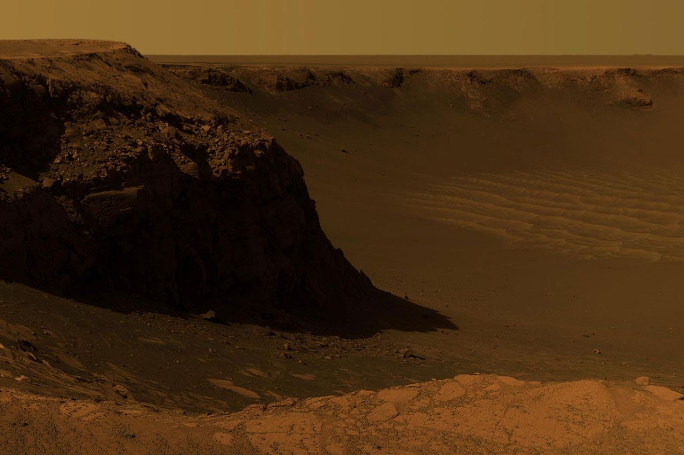 cliff at the crater rim in red-colored desert
