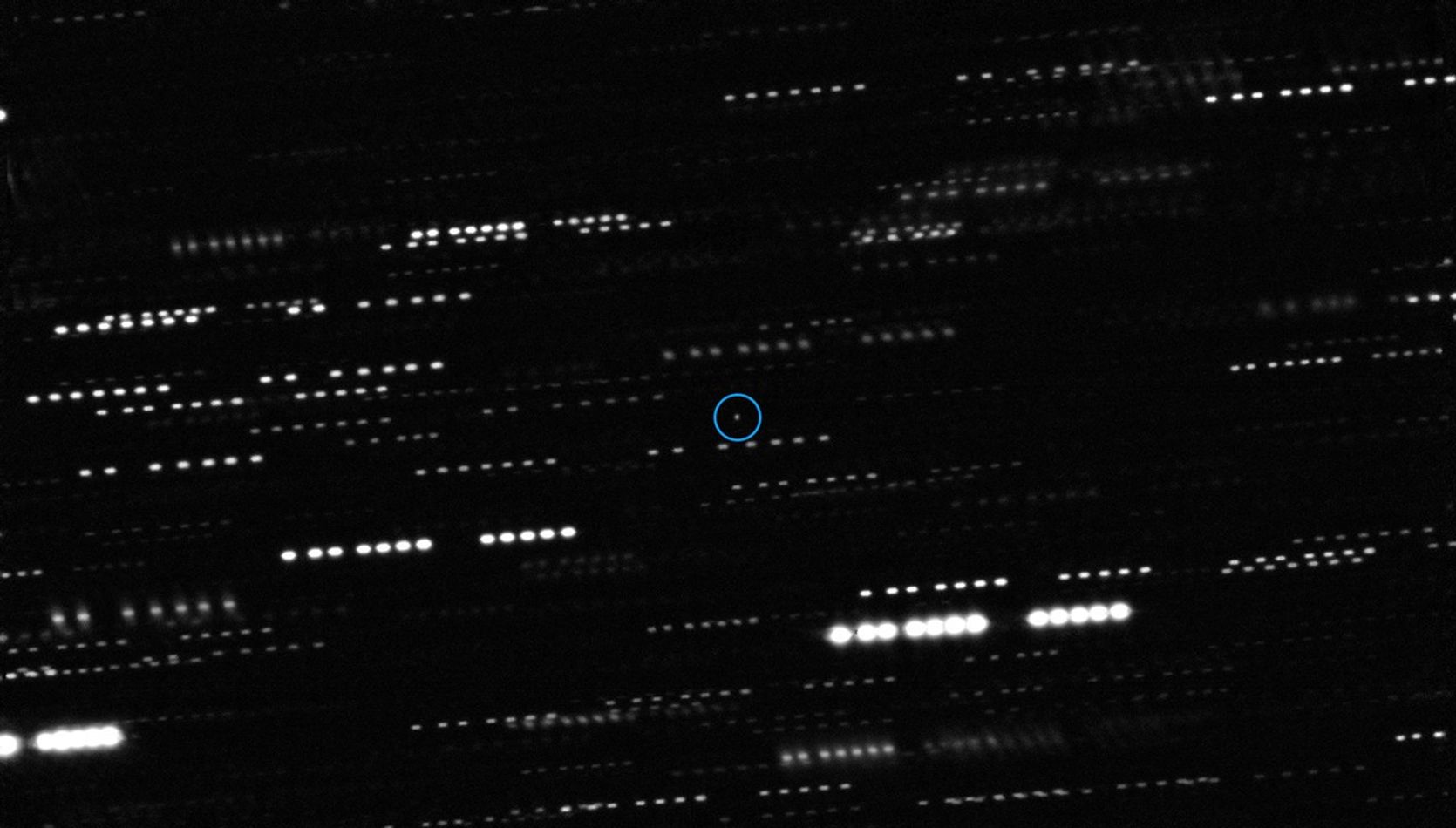 Small object moving against background of stars.