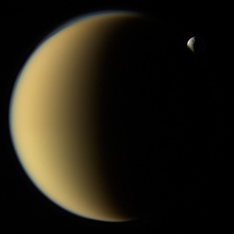 two crescent moons, one appearing much smaller behind the other