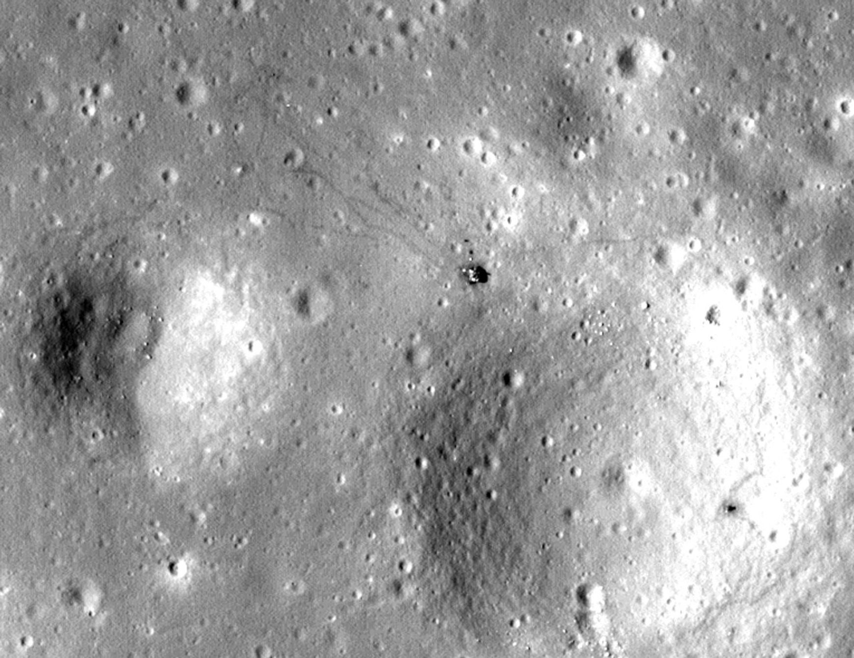 cratered surface and relatively small spacecraft, seen from above