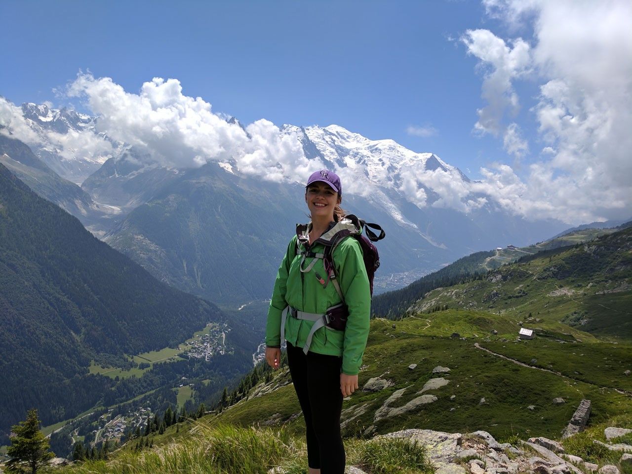 Smiling you woman on mountain peak.