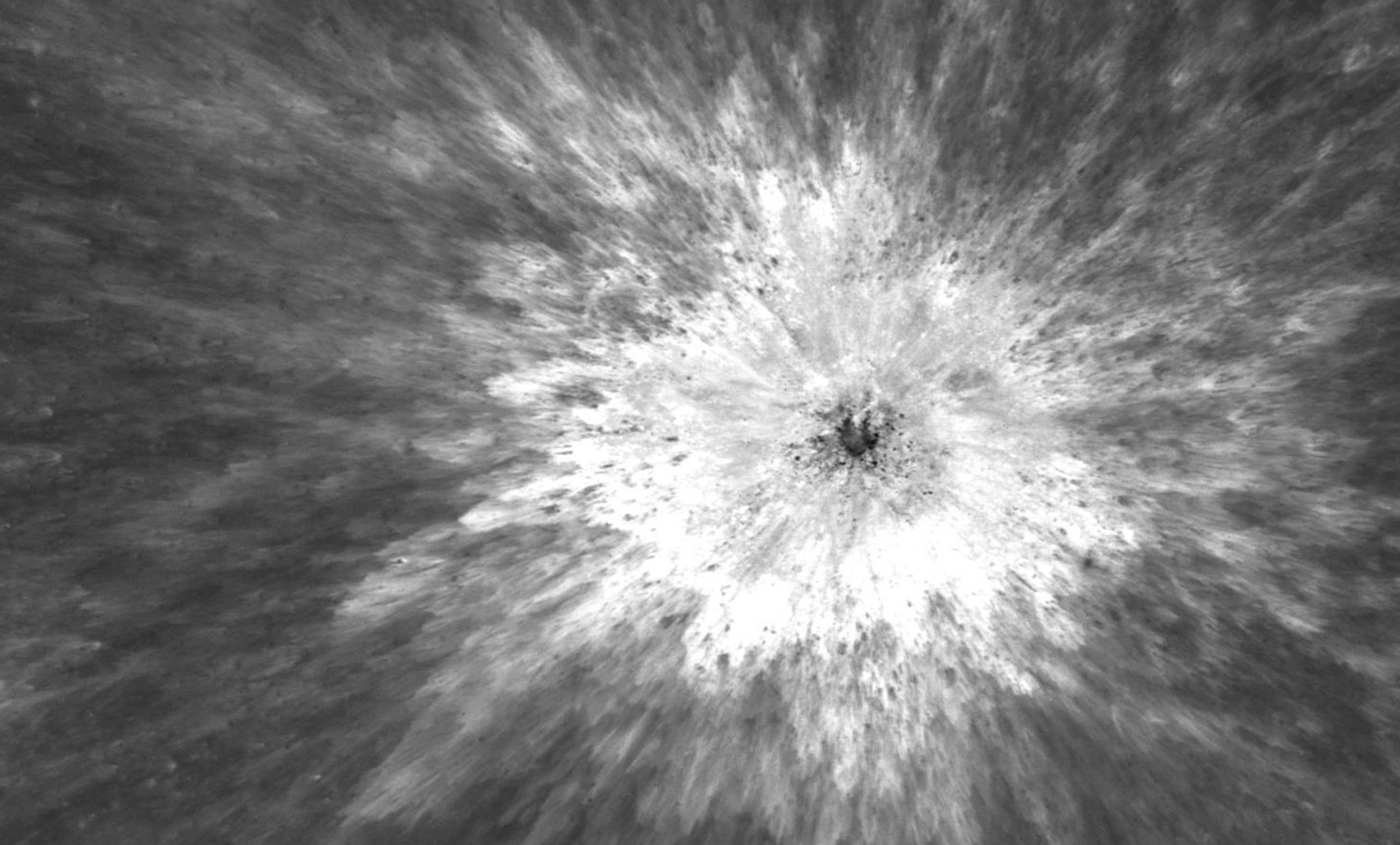 material radiation outward from a central crater, seen from above