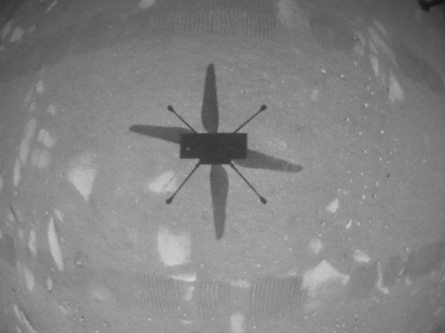 Black and white image of Ingenuity's shadow on Mars