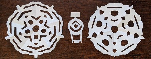 White paper cutouts showing the intricate design of the Lucy spacecraft.