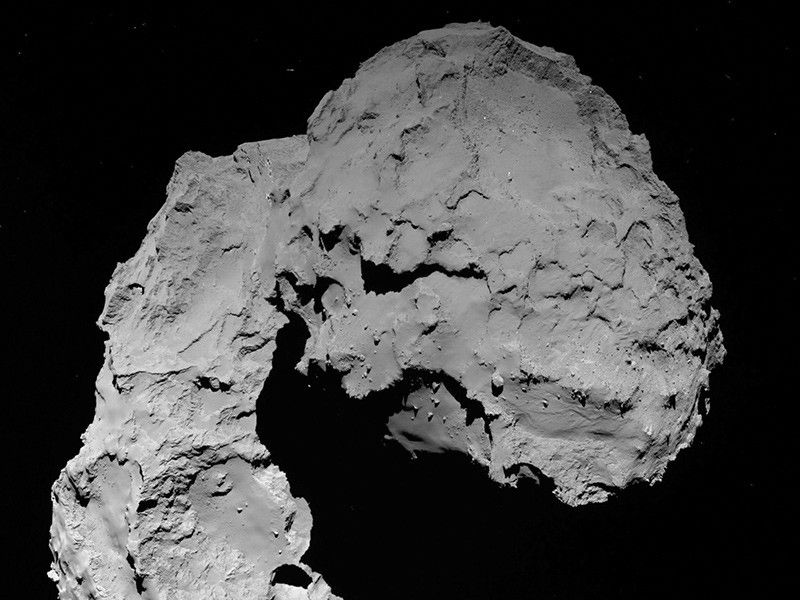rocky comet nucleus venting a jet of gas