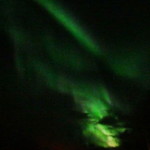 Green bands of light against a night sky.