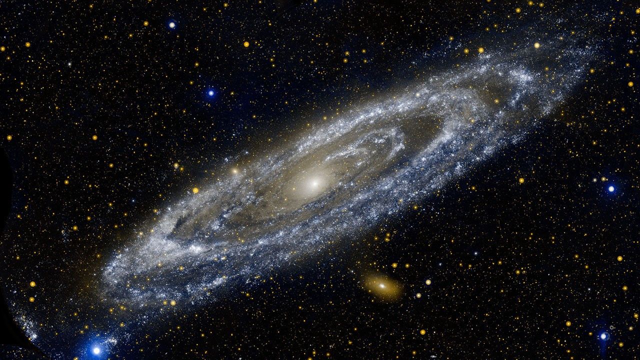 Composite image showing a spiral galaxy. The dust and gas is illuminated by bright stars,