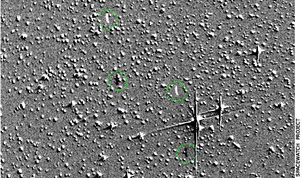 Fuzzy composite image of deep space shows two streaks that indicate the spacecraft broke apart.