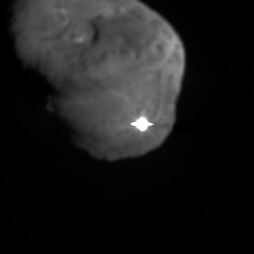 A bright flash is visible on comet Tempel 1 at the moment of impact.
