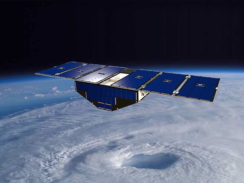Illustration of Spacecraft in orbit about hurricane.