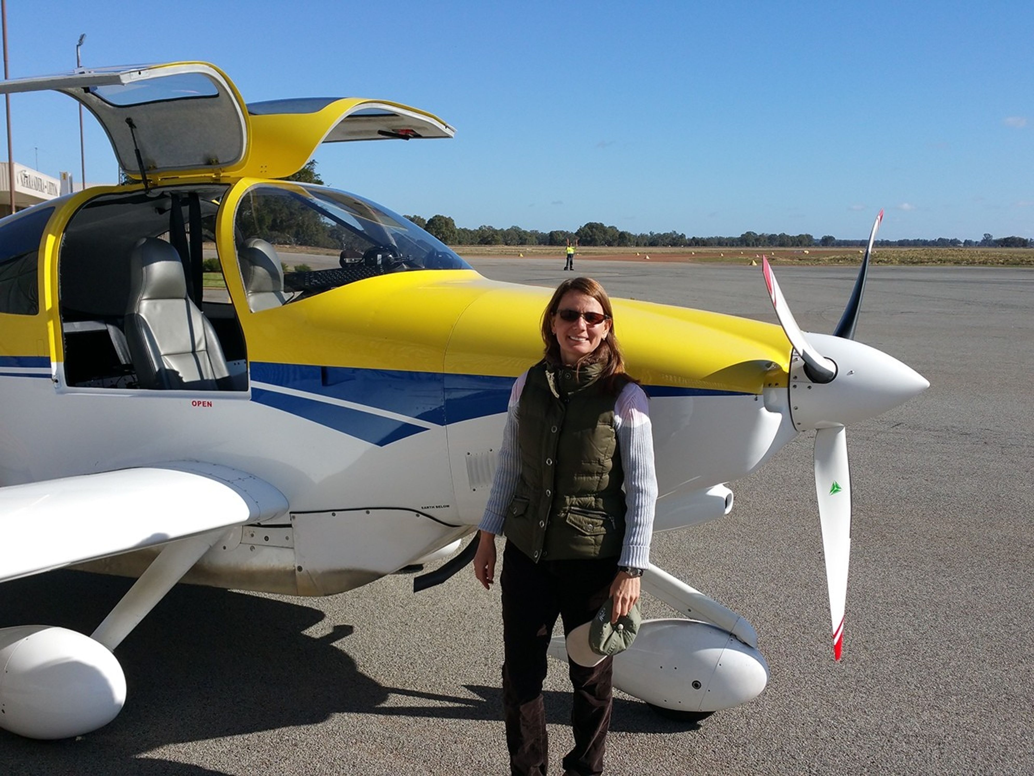 At a Soil Moisture Active Passive (SMAP) campaign in Australia, posing in front of an aircraft that collected measurements in support of the calibration/validation activities. Credit: Erika Podest
